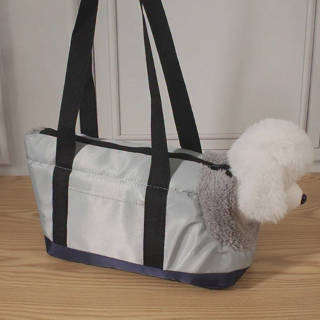 Bolsa portátil para Mascotas, con cuerpo pequeño oculto y cabeza expuesta.
